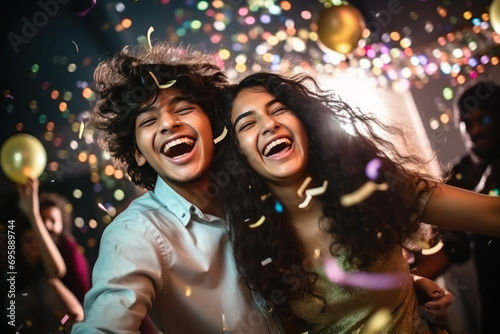 young Indian couple, are laughing and joyful dancing at party © PRASANNAPIX