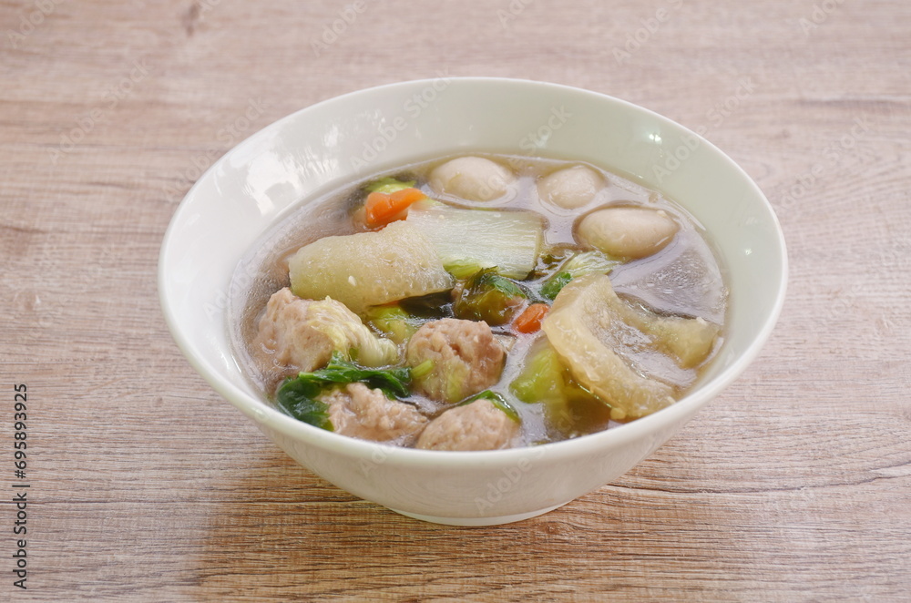 boiled chop pork with fish ball couple cabbage topping seaweed in clear soup on bowl boiled chop pork with fish ball couple cabbage topping seaweed in clear soup on bowl