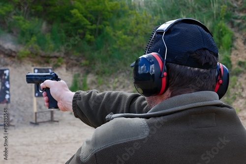 police officers practice shooting a pistol at a target