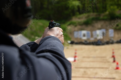 police officers practice shooting a pistol at a target