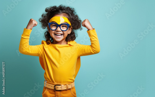 happy little Indian girl wearing a superhero costume