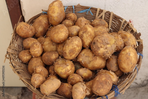 Shot of bunch of Indian Brown potatoes in a wooden Basket or plate