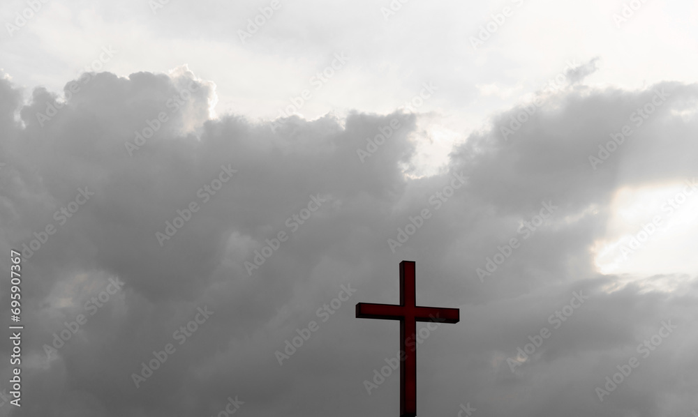 A christian cross under the dark sky