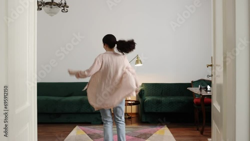 Side view of young Caucasian happy uninhibited woman is dancing in home. Concept of dance learning
