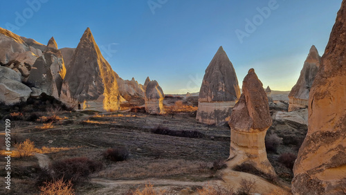 Enchanting view of the fairy chimneys in the Red Valley, Cappadocia—a testament to nature's whimsical artistry.