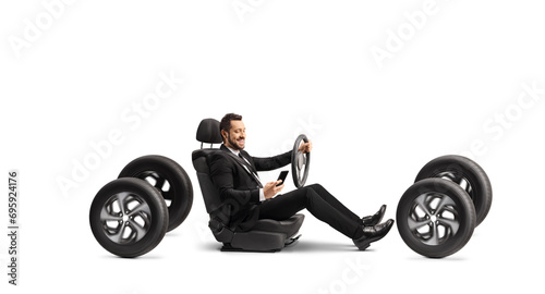 Businessman using a mobile phone and driving photo