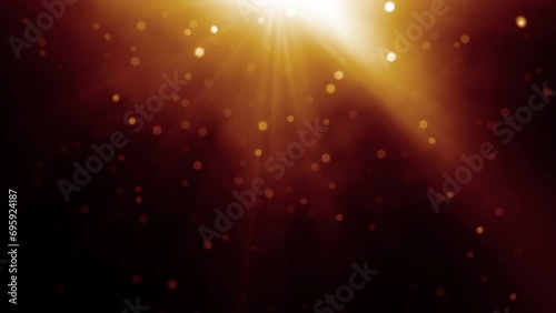 Loop center top gold orange optical lens flares shiny light ray with smoke cloud and falling gold flickering particles animation art abstract backgroundy. Lighting lamp rays effect dynamic bright vide photo