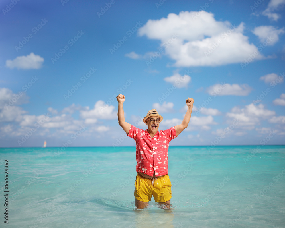 Overjoyed mature tourist on a summer holiday gesturing happiness