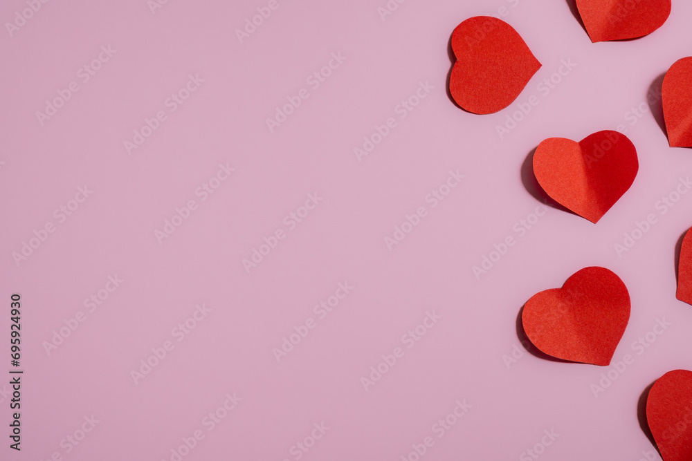 Many red hearts on a pink background, symbol of love, Valentine's Day, happy woman, mother, greeting card design.