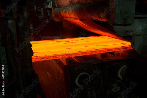 Hot Steel Slabs issuing from a continuous casting machine (CCM) 
