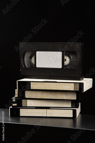 Pile of VHS video cassettes. Vintage media. Dark back photo