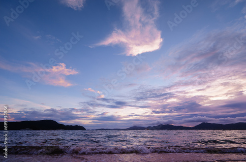 Beautiful blue landscape with sunset on the sea shore. Beautiful cloudy sky.