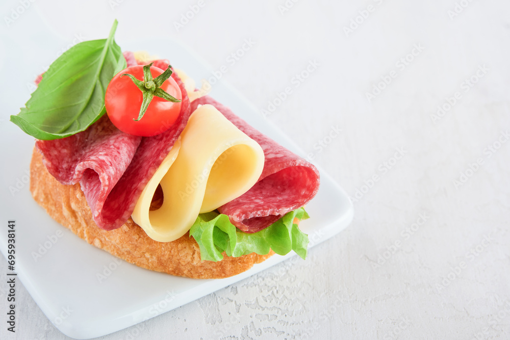 Salami sandwich. Delicious toasted sandwiches with slice salami, cheddar cheese lettuce and tomatoes cherry on white marble background. Restaurant menu, cafe, recipe or article concept. Mock up.