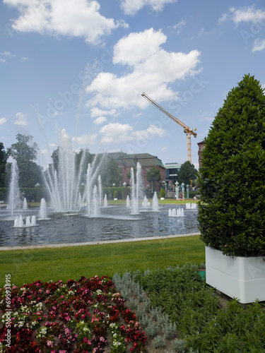 Lively central square with lawns and fountains, in Mannheim, Germany.