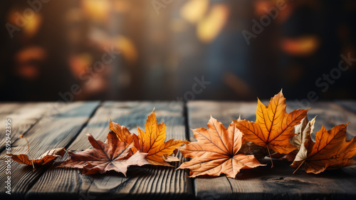 An empty wooden table top with orange leaves in autumn seasonal
