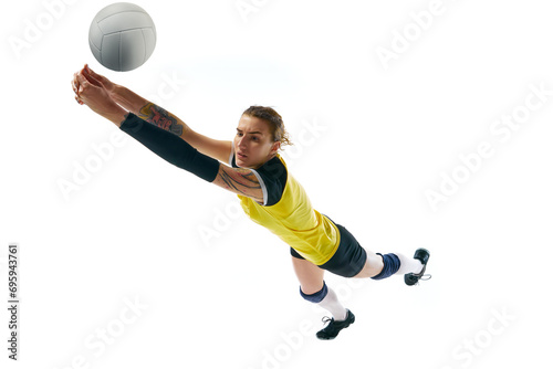 Dynamic competitive young woman, volleyball player in motion during game, hitting ball isolated over white background. Concept of sport, competition, active and healthy lifestyle, hobby © master1305