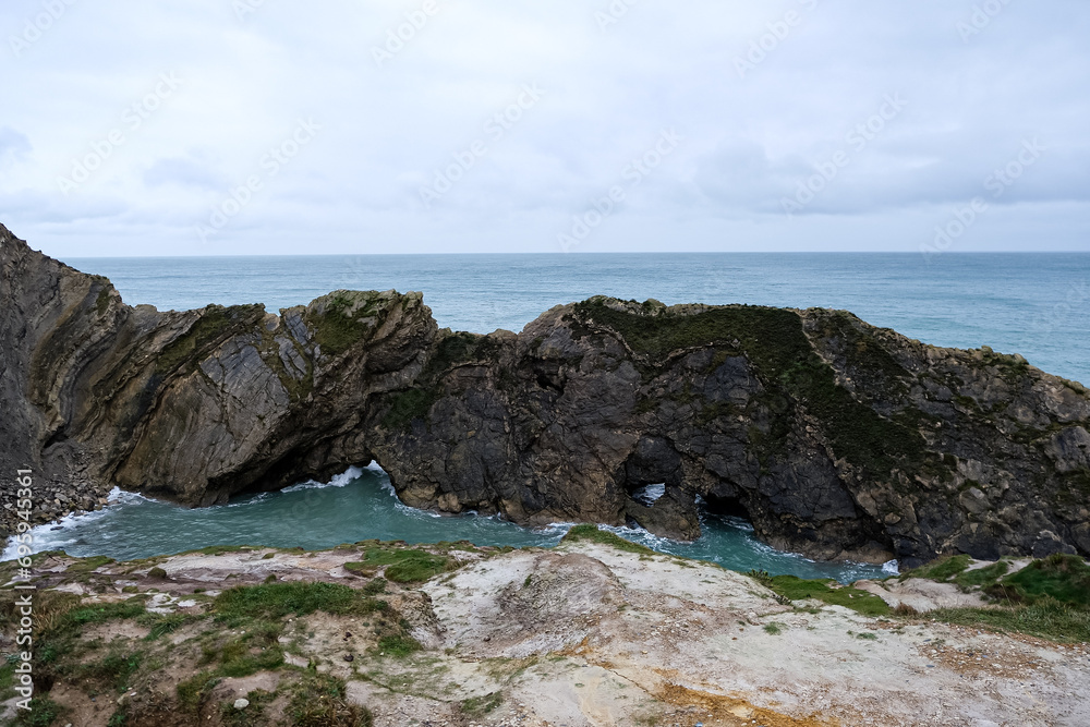 Lulworth Cove cliffs view on a way to Durdle Door. The Jurassic Coast is World Heritage Site on the English Channel coast of southern England. Dorset, UK. Jurassic coast view in Dorset, UK. Stair Hole