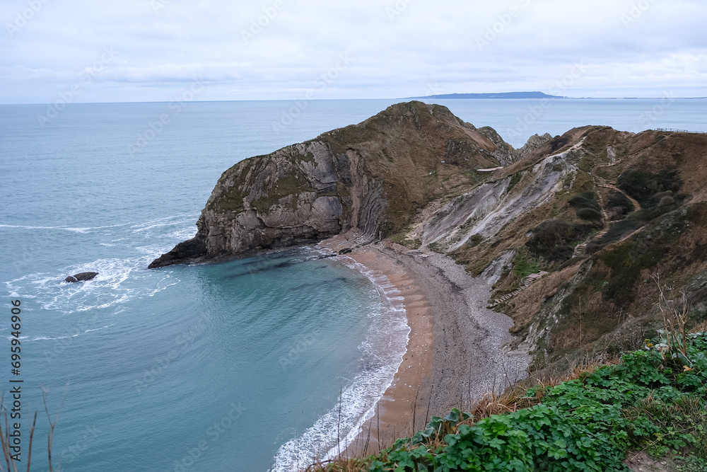 Man O'War Beach and Durdle Door on Jurassic Coast, Dorset, England. Scenic bay surrounded by Jurassic Coast rocks. Winter or autumn days. beautiful landscape and seascape view. English Channel. UK