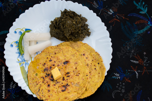 Makki Ki Roti , Sarson Ka Sag in white plate .  selective focus photo