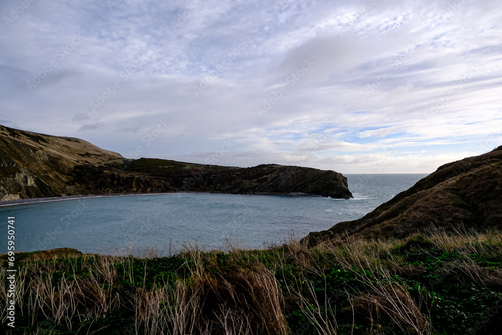 Lulworth Cove and beach view at winter day. Lulworth Cove bay, beach and cliffs view . The Jurassic Coast is a World Heritage Site on the English Channel coast of southern England. Dorset, UK. public 