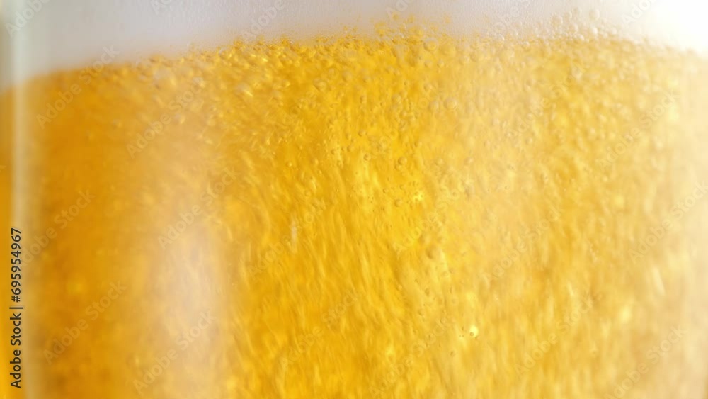 Beer in a beer glass, forming effervescent bubbles and a frothy head. Beer foam flows down the glass. . Detail shot, macro. beer capturing the spirit of octoberfest celebration . alcoholic drink Beer in a beer glass, forming effervescent bubbles and a frothy head. Beer foam flows down the glass. . Detail shot, macro. beer capturing the spirit of octoberfest celebration . alcoholic drink