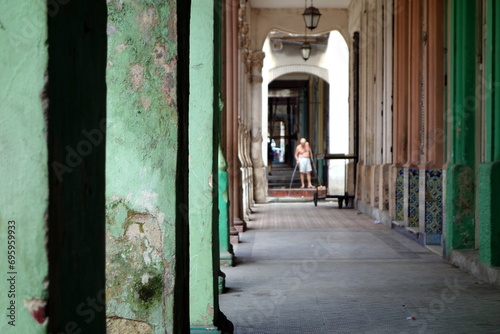 Street life in Havana, old broken building with a man in the backround © Sabrina