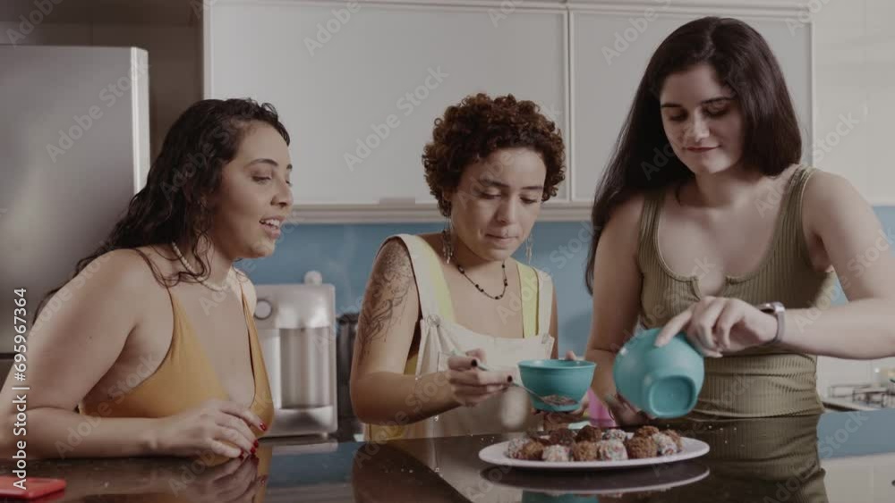 Young women in the kitchen making brigadeiro, a traditional Brazilian dessert. Cinematic 4k. Young women in the kitchen making brigadeiro, a traditional Brazilian dessert. Cinematic 4k.