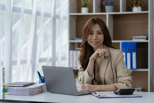 Freelance woman working using laptop computer doing financial accounting analysis to report business investment information