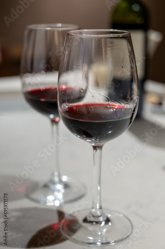 Tasting of red dry Saint-Emilion wine aged in French oak wooden barrels in cellar  Saint-Emilion wine making region  France  Bordeaux