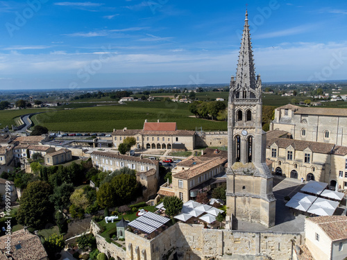 Aerial views of green vineyards, old houses and streets of medieval town St. Emilion, production of red Bordeaux wine on cru class vineyards in Saint-Emilion wine making region, France, Bordeaux photo