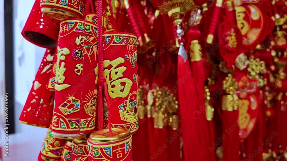 Traditional Chinese red hanging decorations and tassels with intricate golden embroidery and characters, symbolizing luck and prosperity