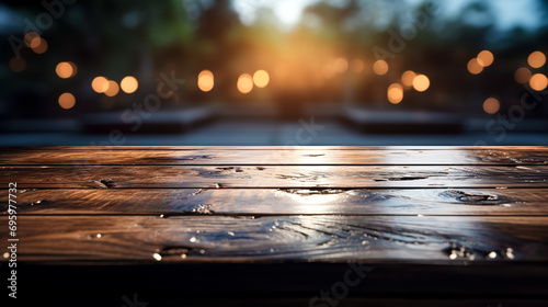 Surface of a wooden table on a blurred nature background with bokeh. #695977732