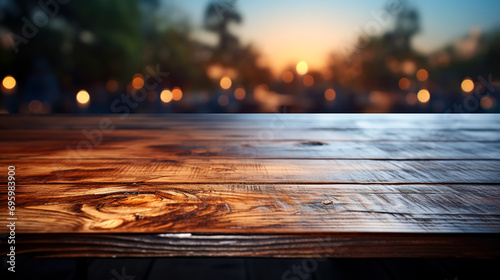 Surface of a wooden table on a blurred nature background with bokeh. #695983900