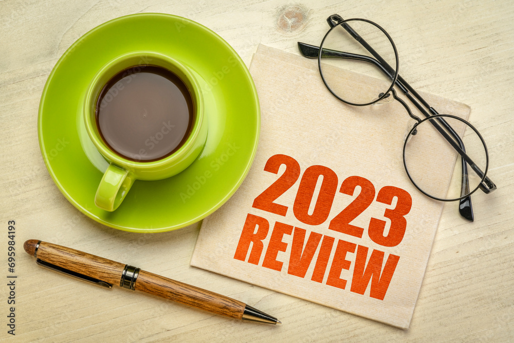2023 year review text on a napkin with a cup of coffee, end of year business concept - obrazy, fototapety, plakaty 