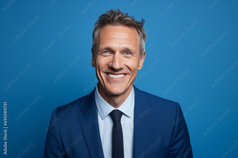 Portrait of a Smiling Businessman with Confident Smile on Blue Background Portrait of a Smiling Businessman with Confident Smile on Blue Background