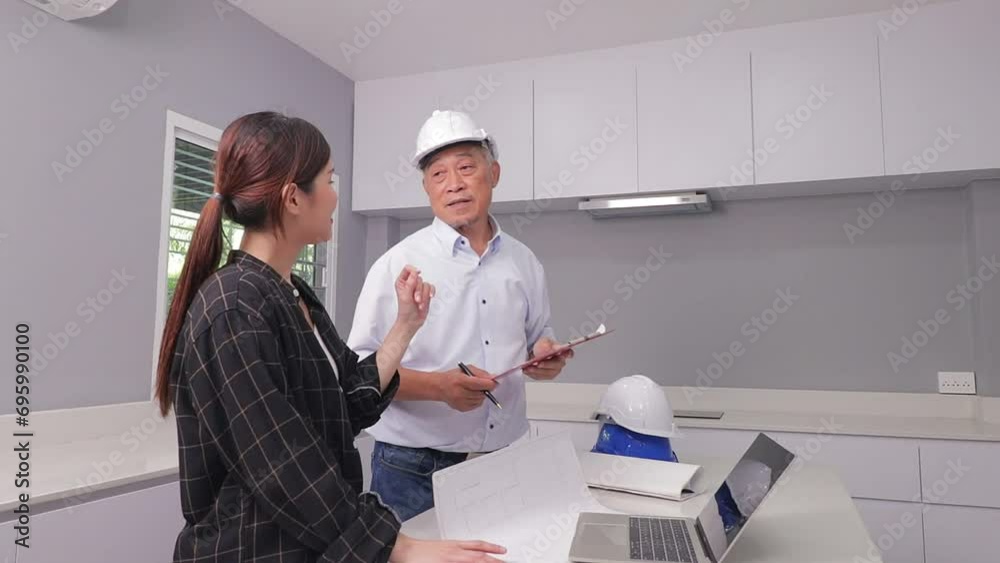 An elderly contractor or engineer or architect discusses work with a female homeowner about home improvements, additions, interior decoration. Home inspection. Architectural concepts. real estate An elderly contractor or engineer or architect discusses work with a female homeowner about home improvements, additions, interior decoration. Home inspection. Architectural concepts. real estate