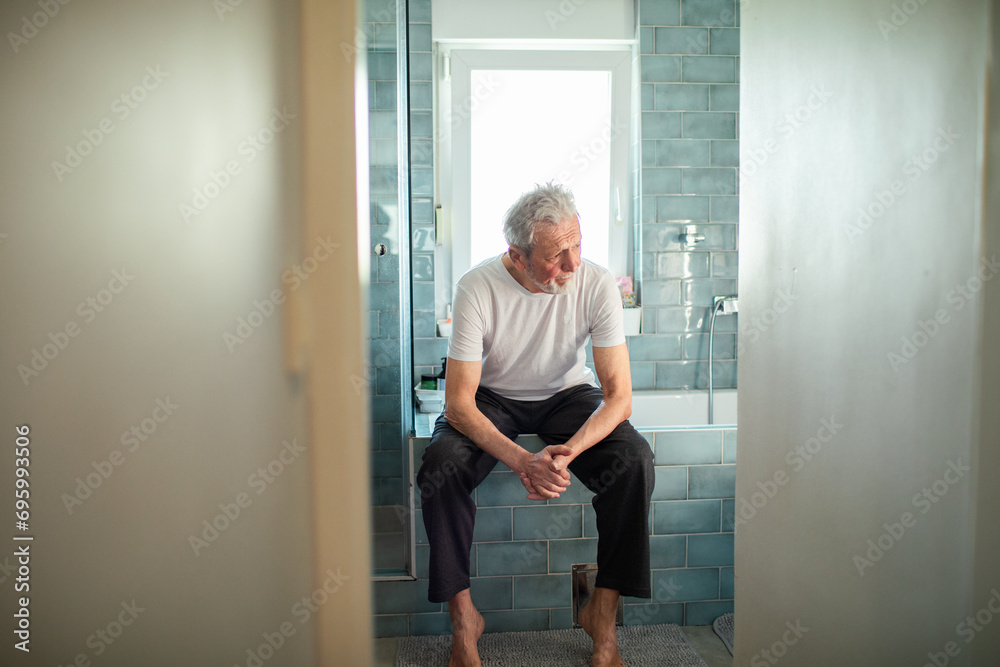 Worried senior man thinking in the bathroom Worried senior man thinking in the bathroom