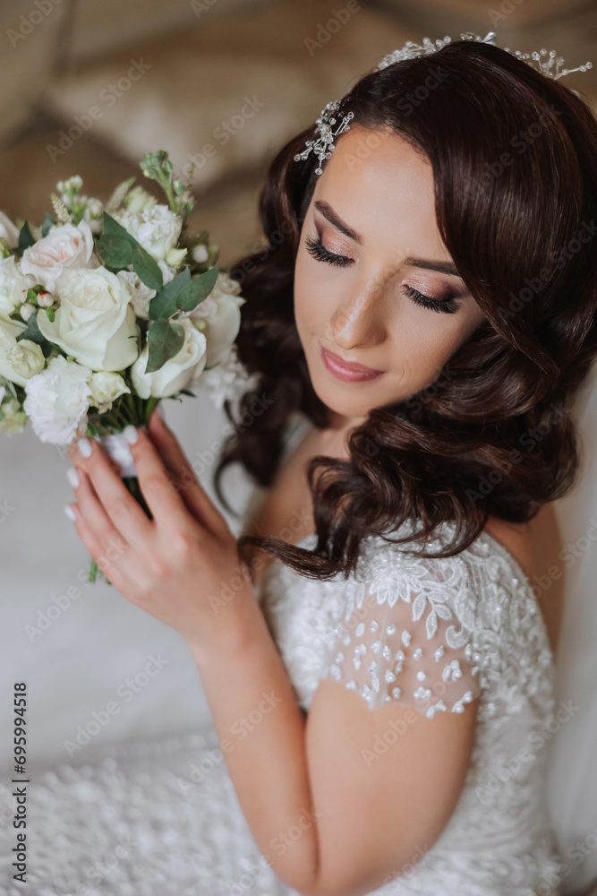 A wonderful beautiful portrait of a young bride. Beautiful bride with wedding makeup and jewelry wreath on long curly hair. Wedding photo model with brown eyes in a beautiful interior. A wonderful beautiful portrait of a young bride. Beautiful bride with wedding makeup and jewelry wreath on long curly hair. Wedding photo model with brown eyes in a beautiful interior.