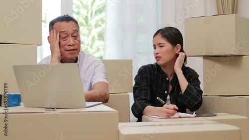 Elderly father and Asian daughter Doing business selling things online Sit and feel stressed because there are no orders from customers. Small business, SME. Entrepreneur photo