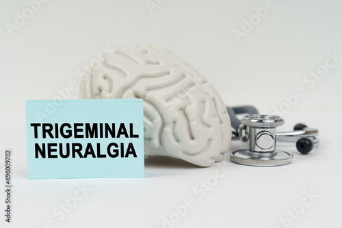 Vászonkép On a white surface next to the brain there is a stethoscope and stickers with th