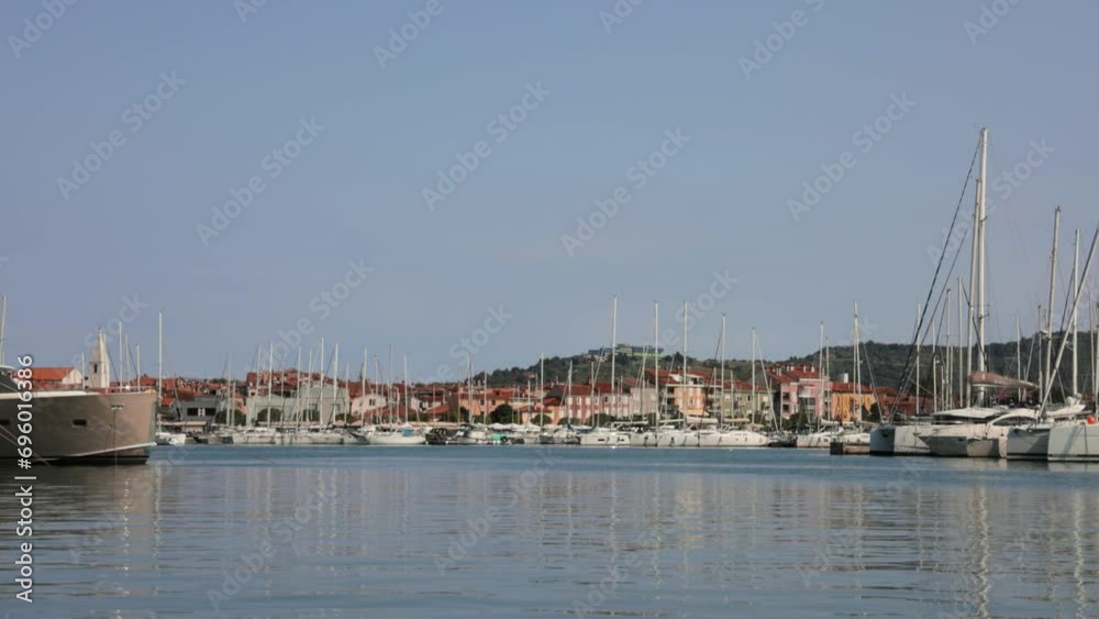 Inside the yacht marina. Masts against the background of the Izola town, Slovenia. Inside the yacht marina. Masts against the background of the Izola town, Slovenia.
