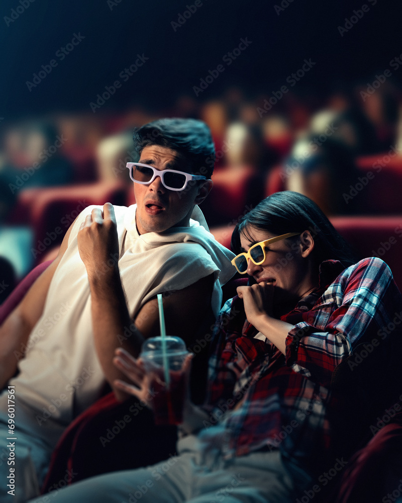 Emotional young man and woman wearing 3D glasses, sitting in cinema and watching horror movie. Emotions of fear. Concept of leisure time, relationship, emotions, weekend activity Emotional young man and woman wearing 3D glasses, sitting in cinema and watching horror movie. Emotions of fear. Concept of leisure time, relationship, emotions, weekend activity
