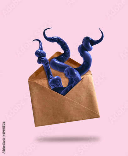 Billede på lærred Purple octopus tentacles stick out of vintage envelope