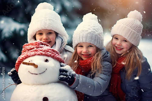 happy children girls making a snowman