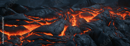 Depict the texture of a frozen lava flow, capturing the rough and dynamic nature of volcanic rock with hints of molten lava solidifying into unique patterns photo