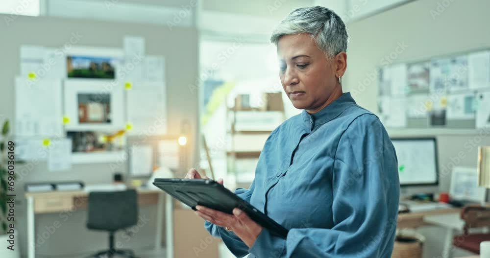 Mature, business woman and scroll on tablet in office for planning research, reading information online and update app. Serious entrepreneur review digital news, software and search social network