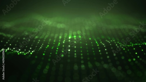 Abstract slow animation of small green dots changing size and color, connected in a network with tilt-shift effect, set against a dark background. photo