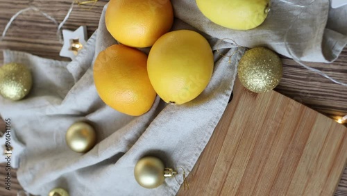New Year's layout of oranges, board, napkins, garlands and balloons on the kitchen table.Preparations for the holiday.Preparing for the celebration of Christmas.The concept of a cozy kitchen