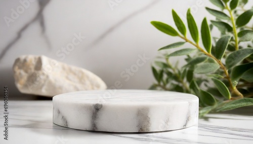 Minimal white marble platform for presentation product with plant and rock stone background