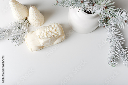 Christmas and New Year composition. Christmas fir tree branches, gifts, pine cones on wooden white rustic background. Flat lay, top view. Copy space. Banner backdrop. Scandinavian houses and candles